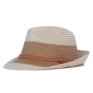 Close-up of woven straw hat featuring two-tone design and brown rope decorative band