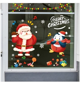 Detail of Christmas window stickers featuring Santa Claus and penguin on glass background