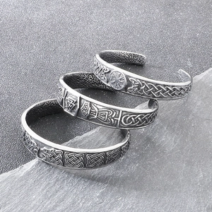 Macro detail of Nordic Viking bangles with engraved Valknut and Vegvisir symbols