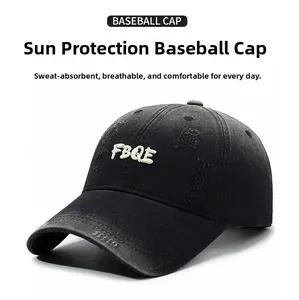 Detailed view of the FBQE 3D embroidery and distressed cotton fabric on black baseball cap