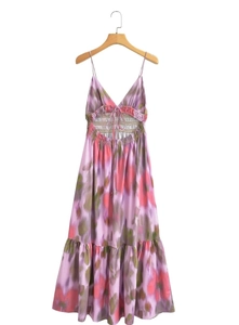 Detail of purple tie-dye dress featuring a backless tie design and tiered skirt hem