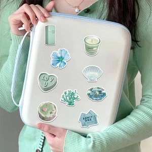 Fresh mint green waterproof stickers on laptop sleeve with floral and hand-drawn patterns
