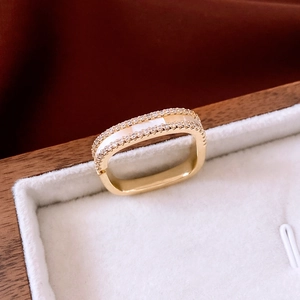 Macro view of 14K gold plated ring with micro-pave zircons and white shell inlay