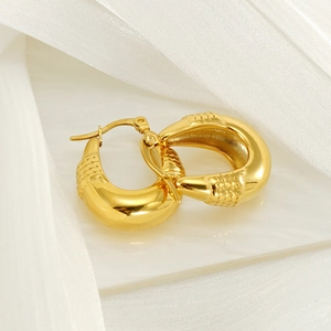 Textured hollow teardrop earrings in gold finish with mirror polish and scale pattern
