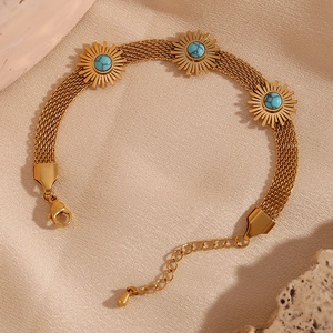Detail of 18K gold-plated braided chain bracelet with turquoise sunflower charms