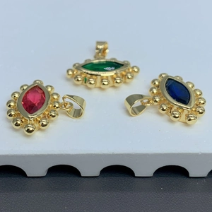 Gold evil eye pendant with vibrant red green and blue zircon crystals in marquise shape