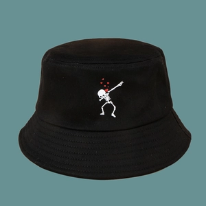Detail of cotton canvas bucket hat featuring a white skeleton dab and red heart embroidery