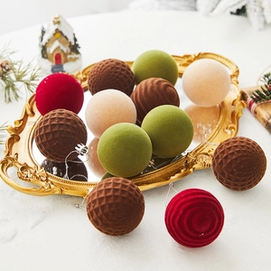 Detail of flocked Christmas balls in retro colors displayed on a vintage gold tray