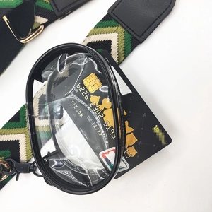 Detail of adjustable woven phone strap featuring a clear round zipper pouch and gold clips