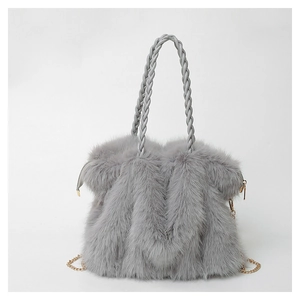 Detail of gray plush tote bag showing long faux fur texture and woven handle with chain