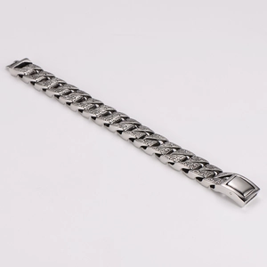 Detail of vintage silver stainless steel bracelet with intricate engraved floral patterns