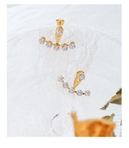 Detailed close-up of 18k gold plated ear jacket earrings with cubic zirconia on lace