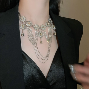 Detail of silver layered fringe necklace with rhinestones worn by a model