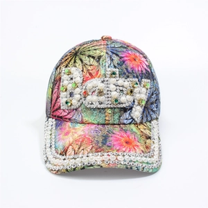 Detail of colorful floral baseball cap with sparkling rhinestones and pearl Baby lettering