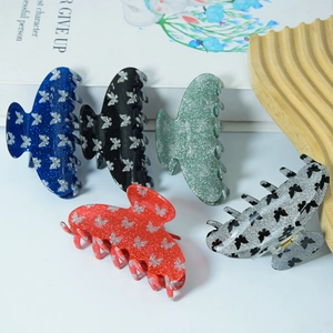 Five-piece glitter butterfly hair claw clips set in various colors on a wooden tray