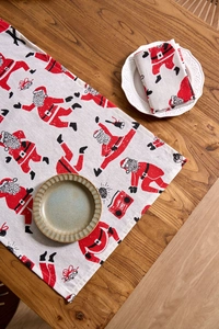 Detail of Christmas napkin with Santa Claus print on rustic wooden table background