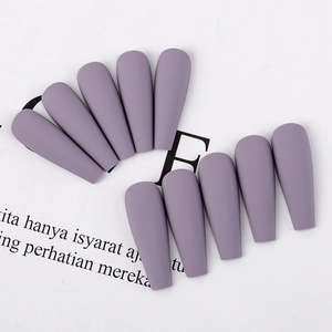 Detailed view of matte purple long coffin press-on nails arranged on a white background