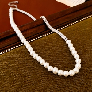 Detail of pearl necklace featuring zircon-paved metal links and adjustable extender chain