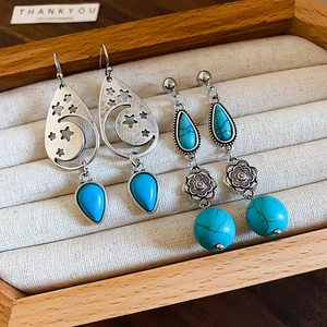Vintage bohemian turquoise earrings featuring silver celestial moon stars and flower drops
