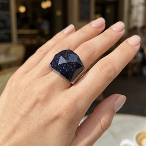 Macro shot of a chunky blue sandstone ring with geometric facets on a silver band