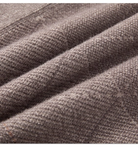 Macro texture of dark brown knit fabric showing soft weave and detailed fiber texture