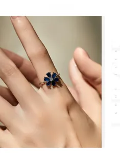 Macro shot of s925 silver ring featuring blue teardrop stones in a floral petal design