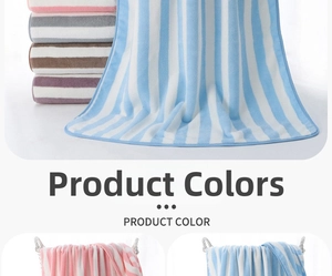 Detailed texture of thick striped coral fleece bath towel in multiple vibrant colors