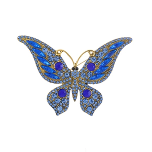 Elegant gold butterfly brooch with blue crystal rhinestones on a white background