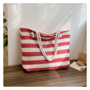 Detailed macro view of woven red and white striped tote bag with sturdy rope handles