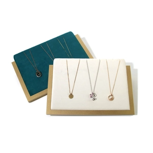 Velvet necklace display stands with gold metal frames in teal and beige colors