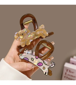 Detail of cartoon puppy and cat hair claws made of high-quality pearlescent acetate material