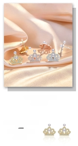 Detailed view of crown shaped pearl earrings featuring zircon accents in three metal colors