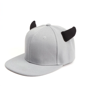 Detail of grey flat brim hip hop hat featuring decorative black 3D 3D devil horns