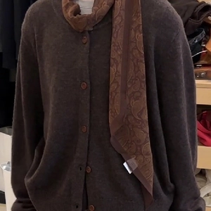 Brown knit cardigan styled with a matching paisley silk scarf for a minimalist look