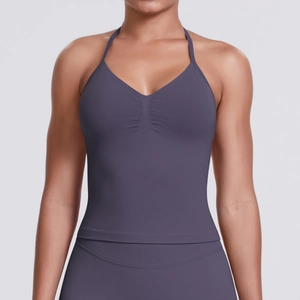 Close-up of halter V-neck sports bra with subtle pleated detailing and premium texture