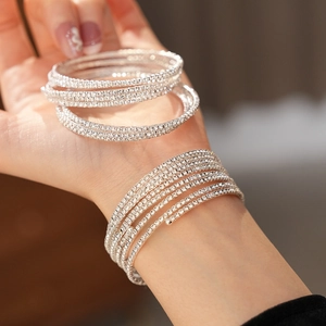 Macro shot of a silver-plated multi-layer spiral bracelet with sparkling crystal inlay