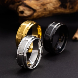 Detailed view of titanium steel rings in silver, gold and black with a brushed finish