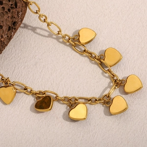 Detailed macro shot of an 18K gold-plated irregular chain necklace with heart pendants