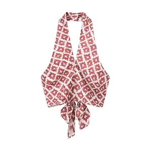 Detail of red and cream geometric print halter top with bohemian tie-up bow hem detail