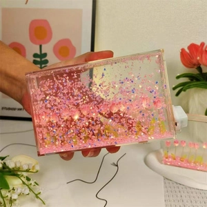 Detail of DIY tulip night light with pink petals and warm LED string in acrylic box