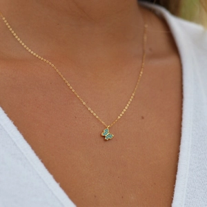 Close-up of S925 silver butterfly necklace with turquoise stones on a female model