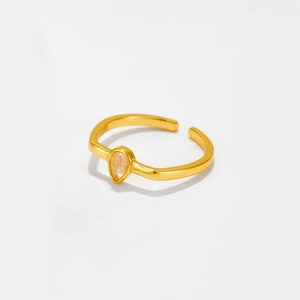 Close-up of golden adjustable s925 silver ring featuring a clear pear-shaped gemstone