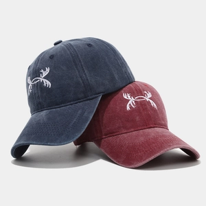 Vintage washed baseball caps in navy and burgundy with white antler embroidery detail