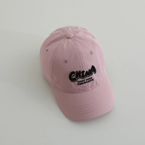 Detail of pink baseball cap with black CHINA embroidery and premium cotton texture