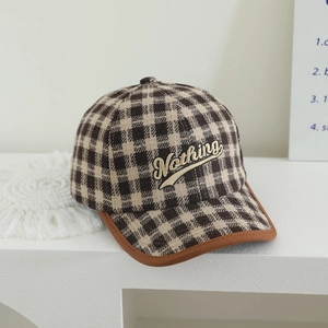 Macro view of plaid kids baseball cap featuring 3D Nothing embroidery and leather piping