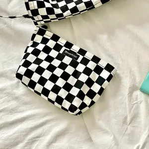 Black and white checkerboard canvas makeup bag with zipper and Moonshine label
