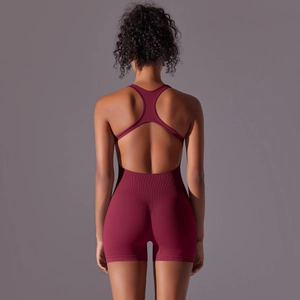 Detail view of the deep wine red ribbed one-piece yoga jumpsuit with open back design