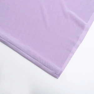 Macro view of light purple mesh fabric texture and fine stitching on the dress hem