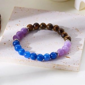 Macro view of 8mm natural stone beaded bracelet with tiger eye and silver spacers