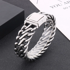 Detailed view of heavy vintage silver stainless steel cuban chain bracelet on black background